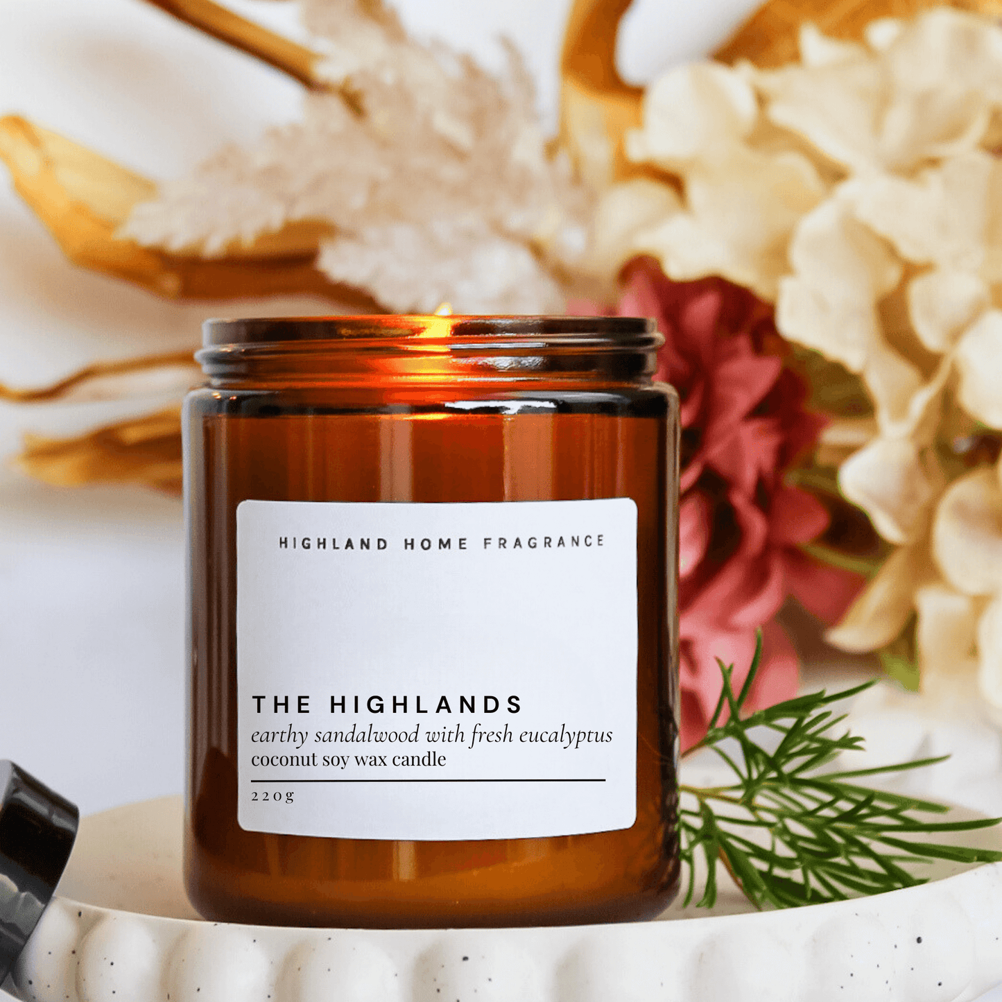 The Highlands Sandalwood and Eucalyptus Scented Amber Jar Candle 200G from front angle from Highland Home Fragrance. Coconut Soy Wax Candle.